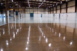 chemical-resistant, clear aliphatic polyurethane finish coat on pigmented concrete floor