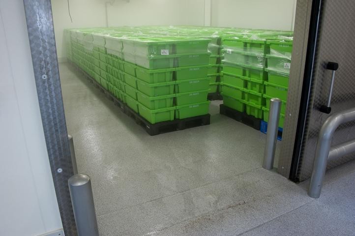 Storage room with green containers on epoxy flooring